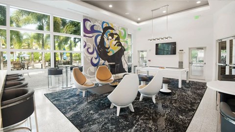 a living room with a table and chairs and a large wall of windows